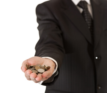 Man In suit holding out a hand full of coins